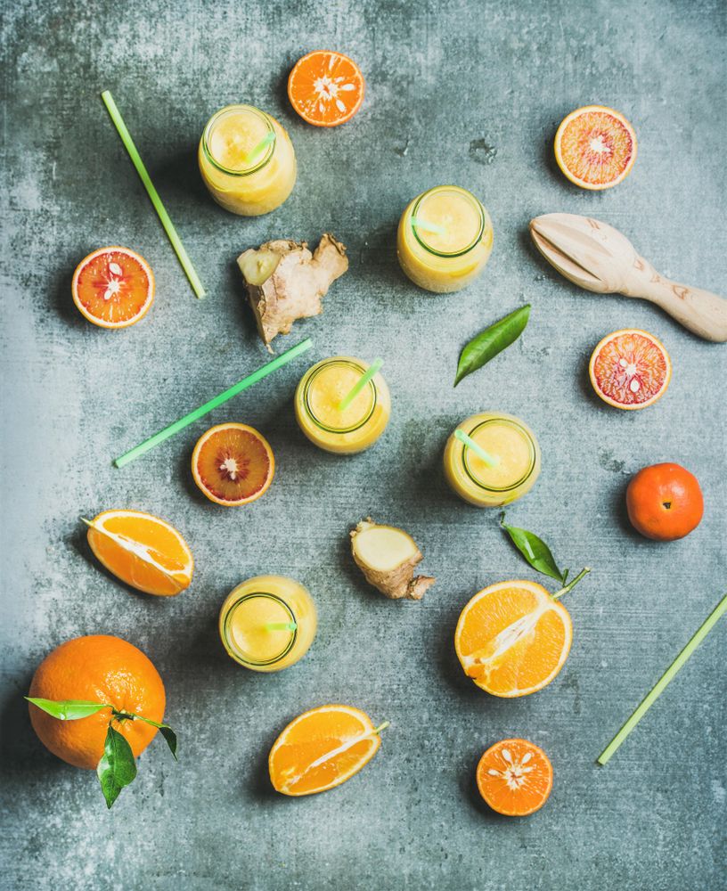 Top view of citrus fruit and juice with ginger