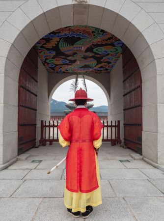 Seoul, South Korea - August, 08 2017: Anonymous man in traditional Korean clothes near archway
