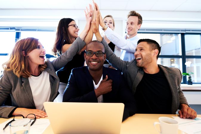 Group of co-workers celebrating in an office