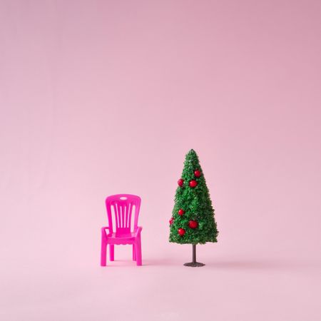 Christmas tree with pink chair, on pink background