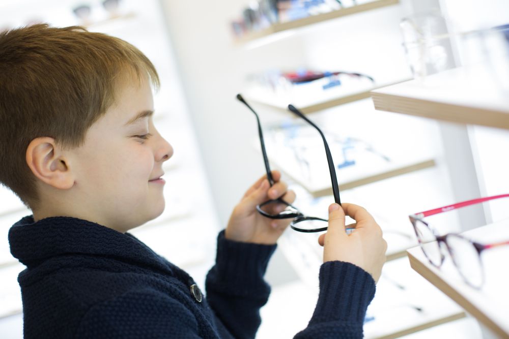 Young boy trying on glasses