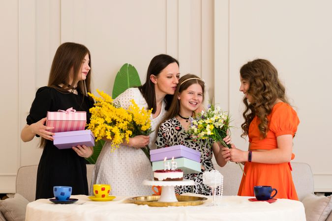 A woman and two girls celebrating a birthday
