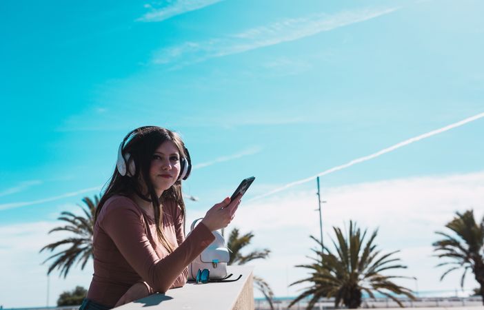 Woman listening to music at handrail