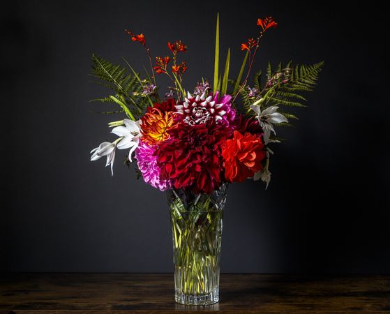Full bouquet in vase in dark room