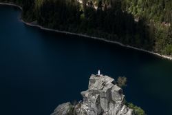 Religious statue overlooking a lake