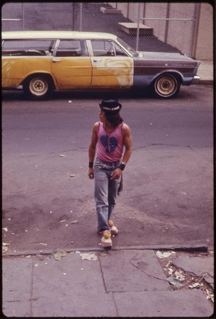 Trendy hispanic man crossing the street in New Jersey 1974