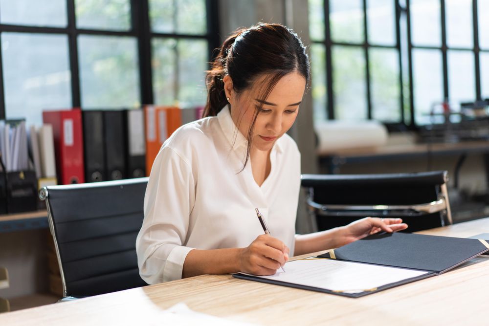 Female reading through report at work