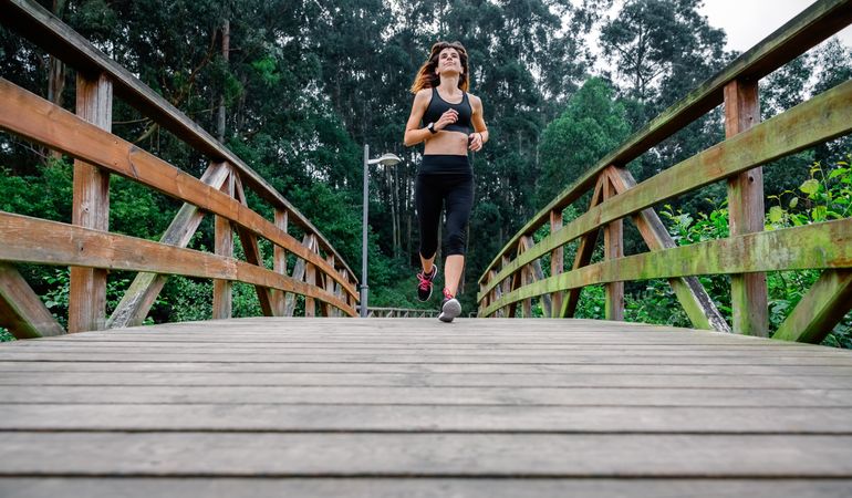 Woman running through an urban park