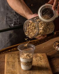 Chef adding oat to granola parfait