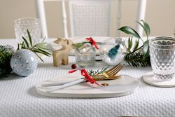 Holiday celebration table setting, marble dish and golden cutlery.