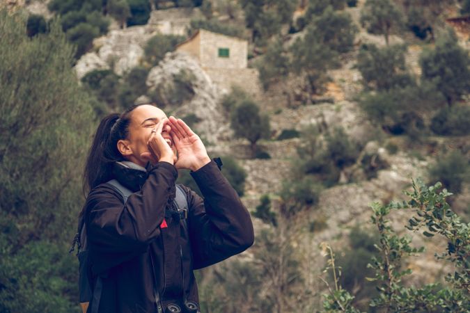 Female tourist straying in mountains and shouting loudly
