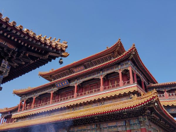 An ancient Chinese temple with red and yellow as dominant colors, typically used for praying, exuding a sense of spiritual reverence and architectural beauty
