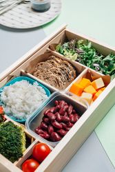 Food box with diet ingredients by copybook and plate