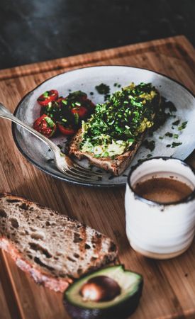 Avocado toast on sourdough bread, with cherry tomatoes  coffee and avocado