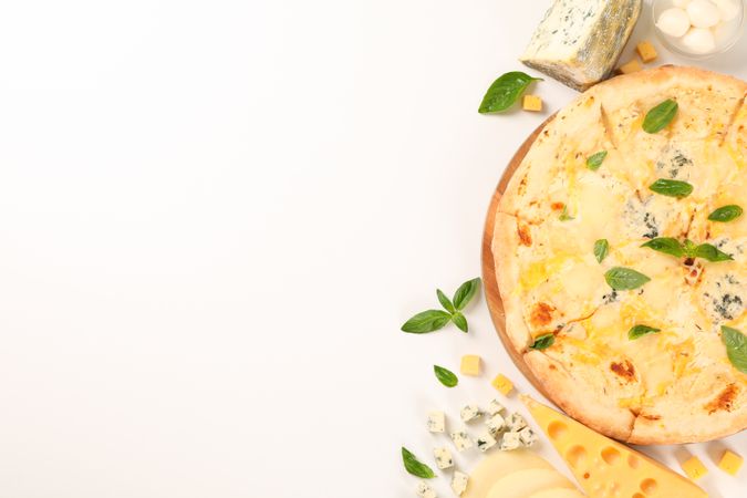 Flat lay. Cheese pizza and ingredients on plain background, copy space