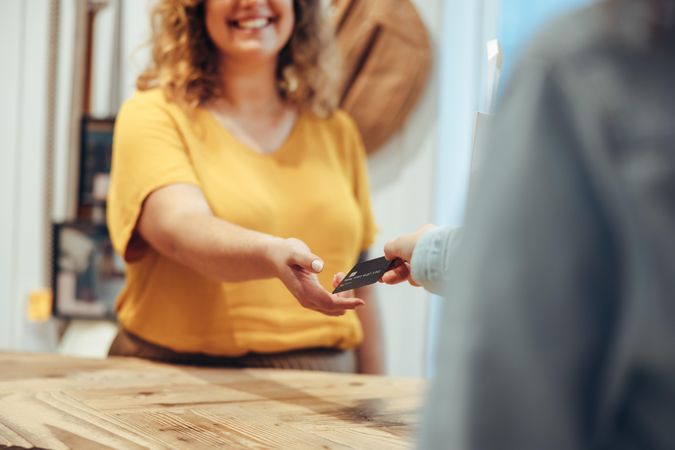 Saleswoman taking credit card payment from customer