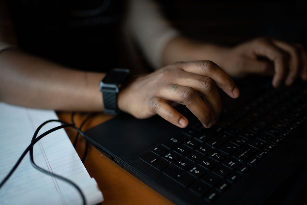 Black person using laptop computer