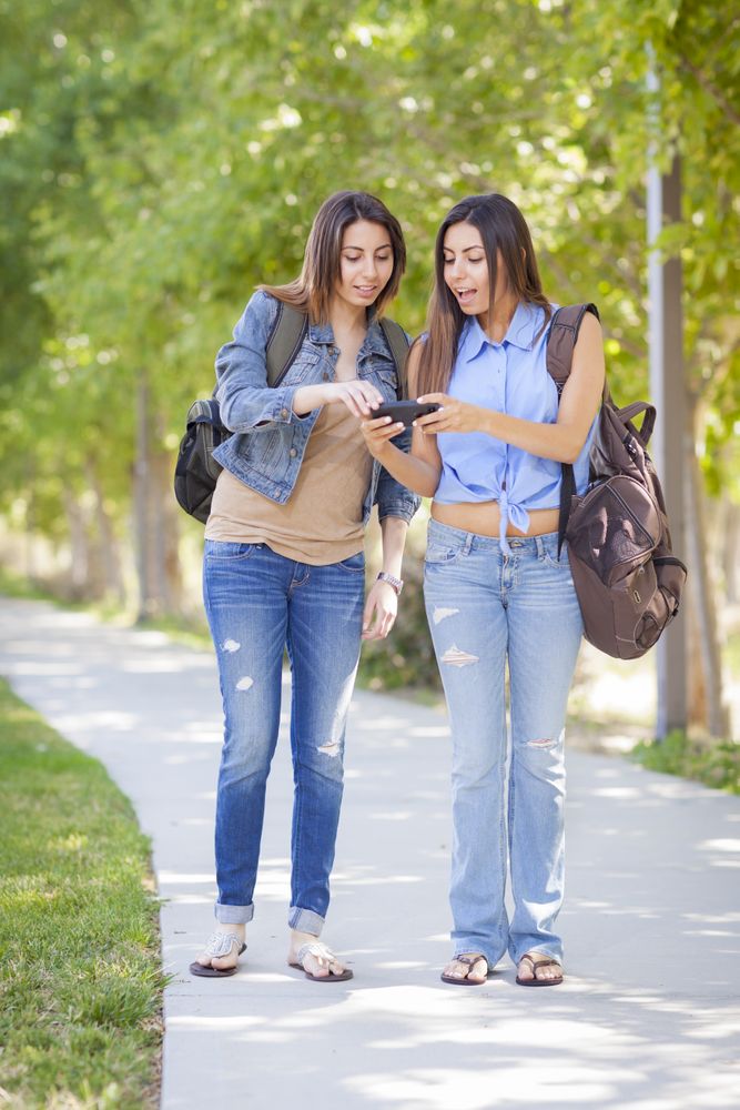 Twin Sisters Sharing Cell Phone Experience