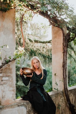 Romantic woman with musical bowl in castle