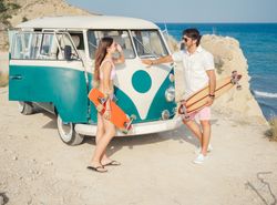 Man and woman chatting leaning on trailer at seaside