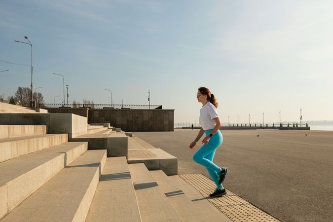 Young woman running on city streets