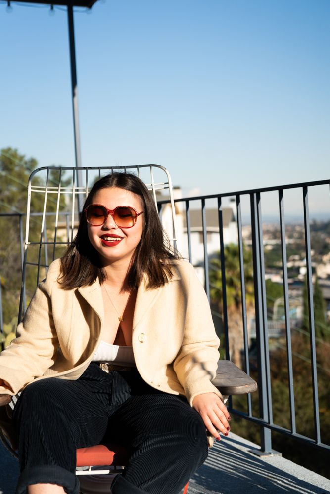 Woman smiling with eyes closed outside on patio