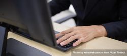 Hand of male employee typing on computer keyboard at desk 49KLB0