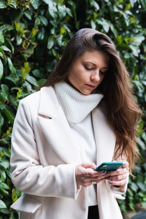 Content woman using smartphone in park