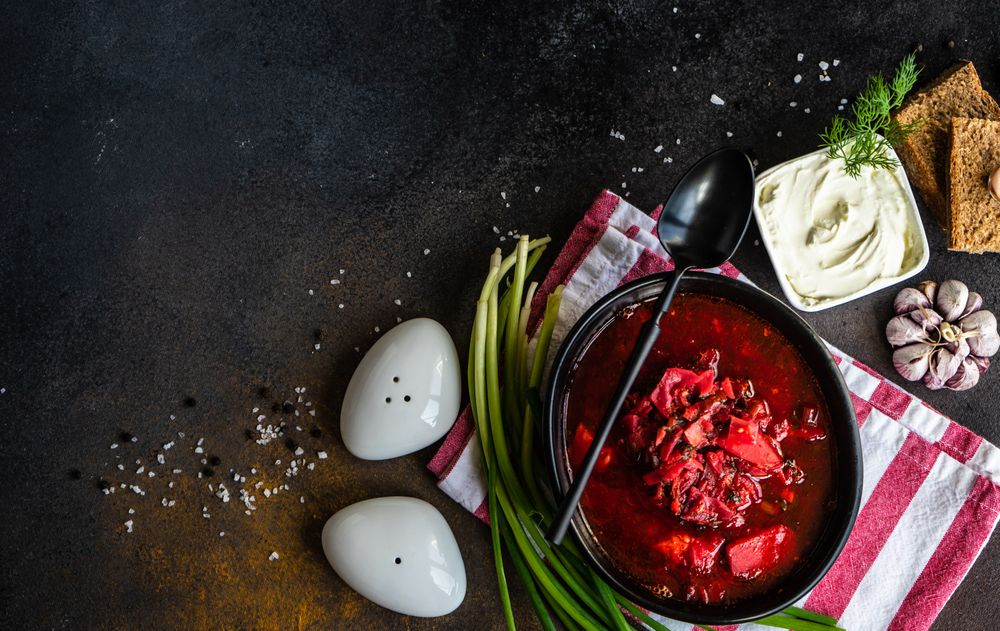 Top view of Ukrainian beetroot soup borscht on counter with copy space