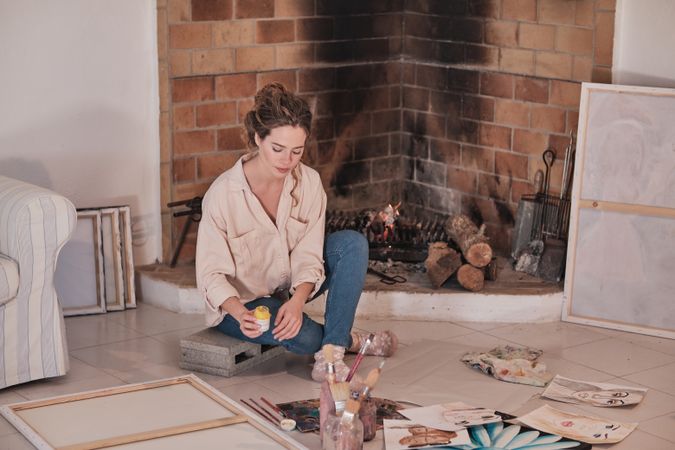 Young woman painting in studio