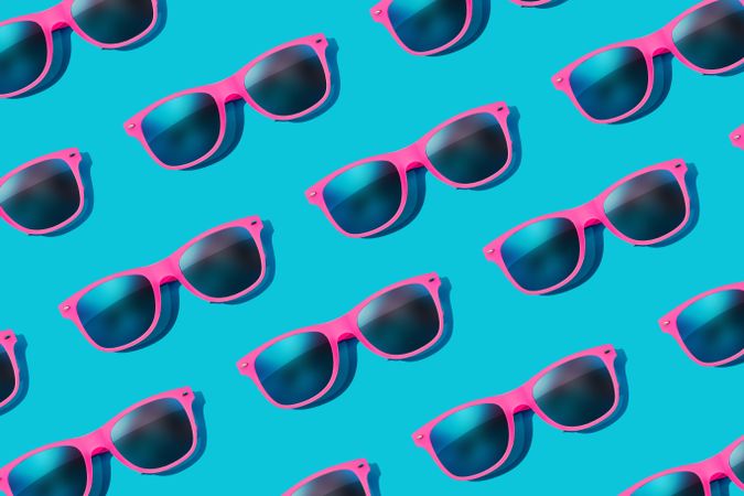 Pattern of pink sunglasses on blue background