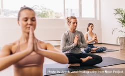People meditating in yoga class 5r9vZ3