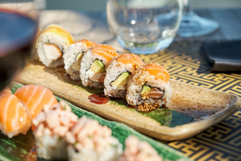 Delicious sushi served on ceramic plate
