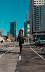 Woman with afro hair walking through the streets