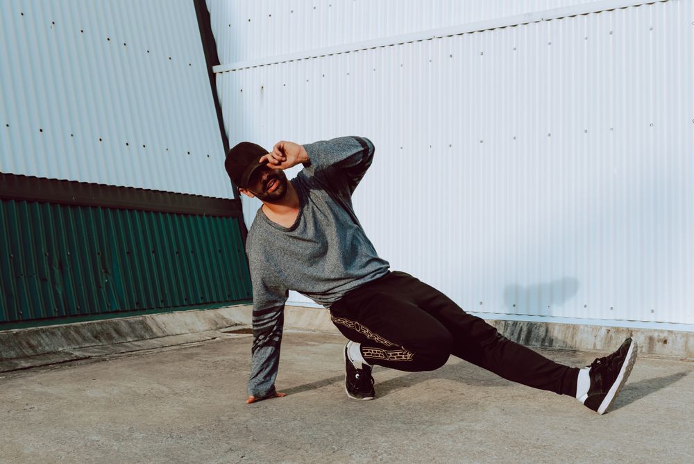 Man performing handstand near wall