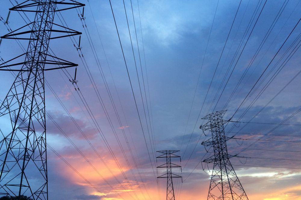 Electricity Transmission Towers Under a Beautiful Sunset Sky