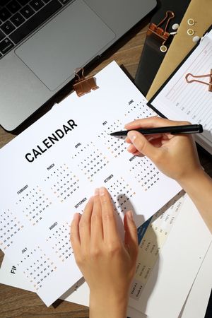 Top view of person reviewing a calendar