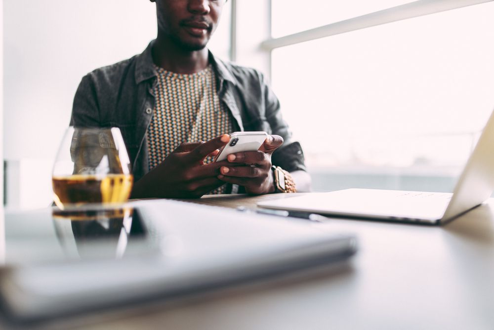 Man using mobile phone at desk