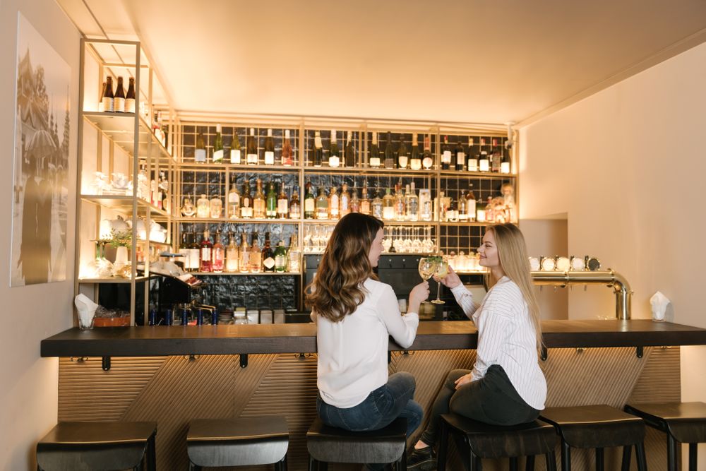 Cheerful women drinking cocktails in bar