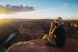 Man drinking near canyon