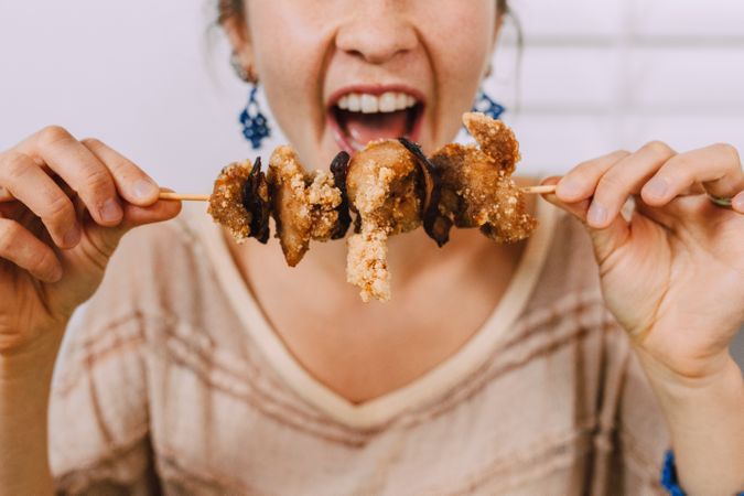 Cropped image of hungry woman about to eat a skewer
