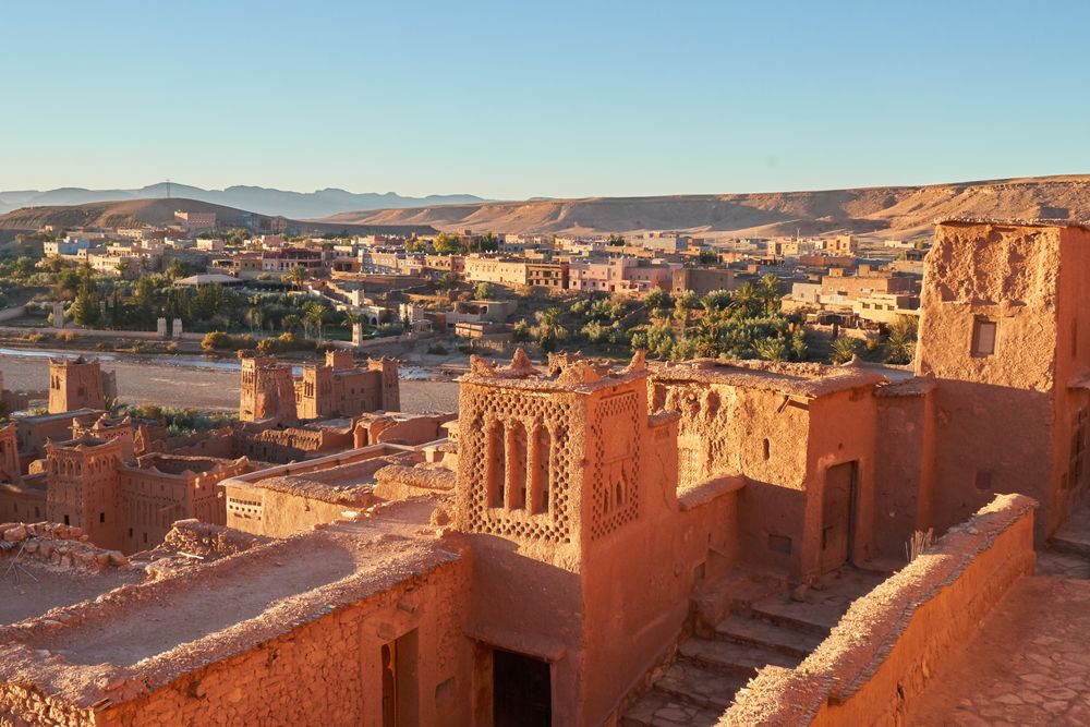 Ancient city near river in desert and wonderful sky