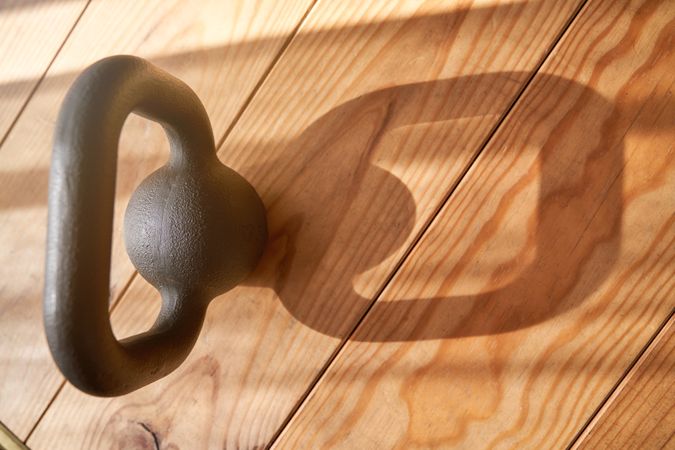 Metal kettlebell on wooden floor
