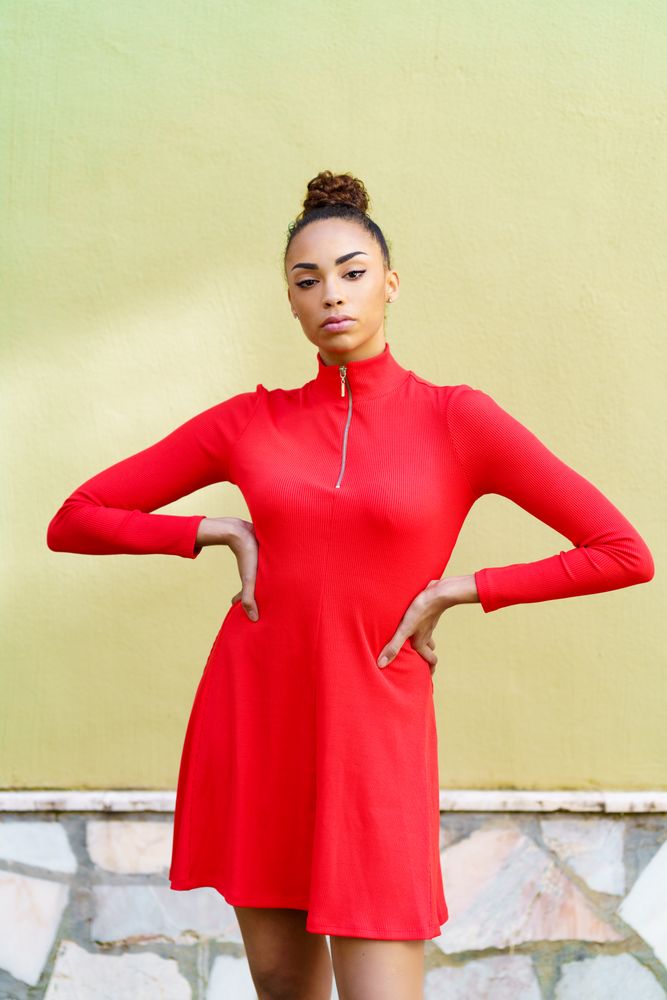 Serious female in casual red dress