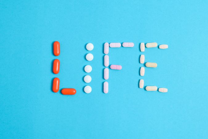 Multiple pills making the word "LIFE"