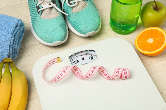 Healthy lifestyle accessories on neutral background, space for text