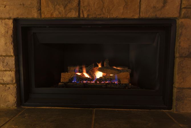 Natural gas insert fireplace for heating home