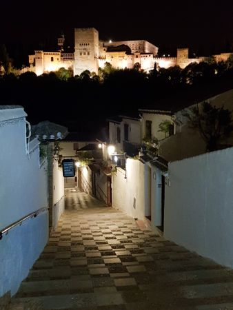 Night view of the famous Alhambra palace in Granada from Albaicin quarter from passage