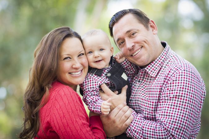 Little Baby Boy Having Fun With Mother and Father Outdoors