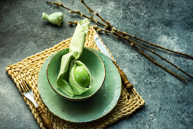 Easter holiday table setting with pastel egg wrapped in rabbit napkin